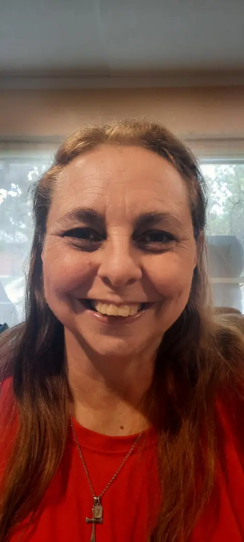 Smiling woman in red shirt indoors