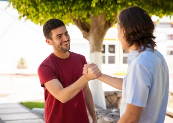 Two men greeting each other outdoors