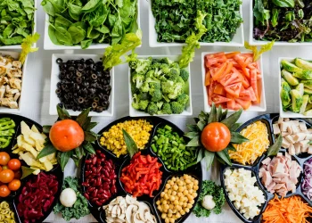 Colorful salad bar ingredients displayed in dishes.